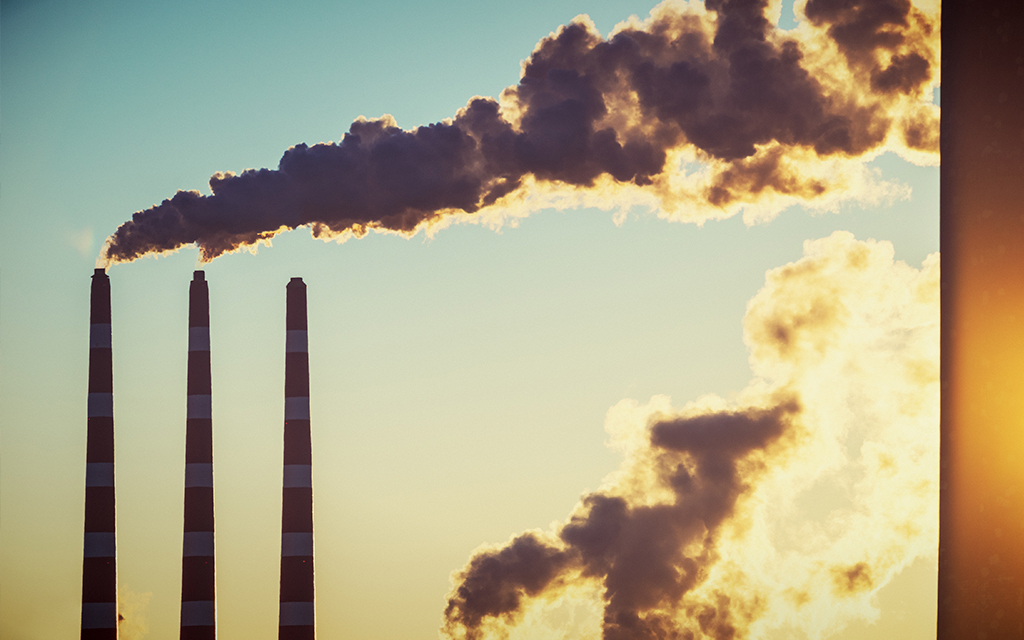 Chimneys bellowing smoke in the sunlight
