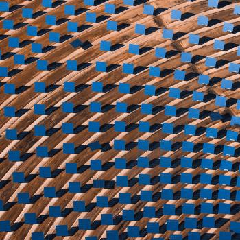 Aerial view of rows of solar thermal panels in a desert solar energy plant.